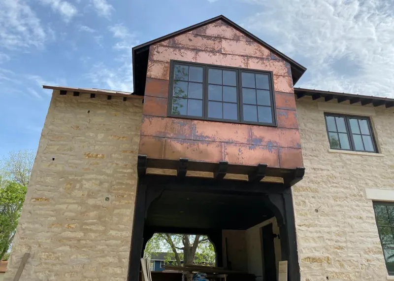 Copper metal panel facade on a stone building for Skylight Installation in Walker