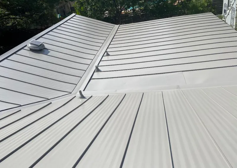 Solar attic fan installed on a metal roof for Roof Ventilation in Walker